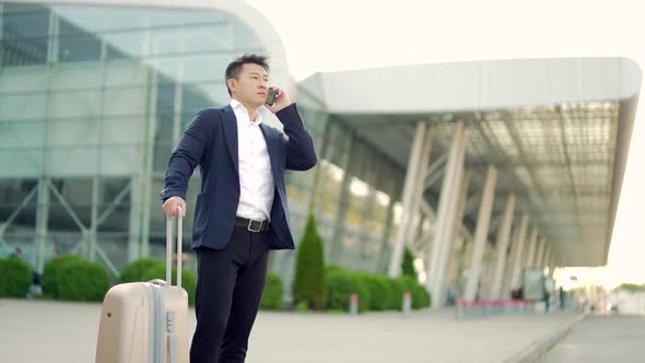 Asian business man standing background a modern train station airport in formal