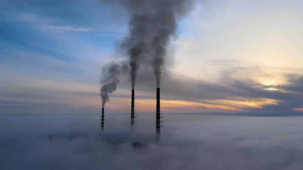 Coal Power Plant High Pipes with Black Smoke Moving Upwards Polluting Atmosphere