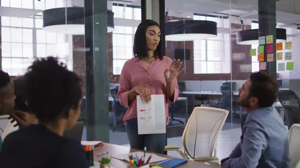 Mixed race businesswoman having a meeting with colleagues in meeting room