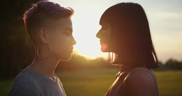 Two Lesbian Women Kissing on Sunset