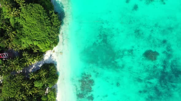 Aerial seascape of beautiful island beach break by blue sea and white sandy background of a daytrip 