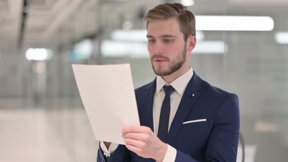 Young Businessman Reading Documents