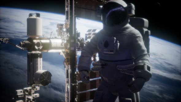 International Space Station and Astronaut in Outer Space Over the Planet Earth alt