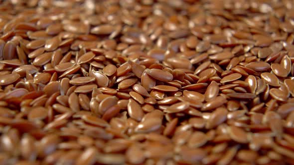 Flax seeds heap close up. Brown linseeds. Macro