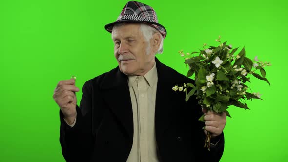 Elderly Caucasian Grandfather Man with Bouquet of Flowers and Ring Goes on Date