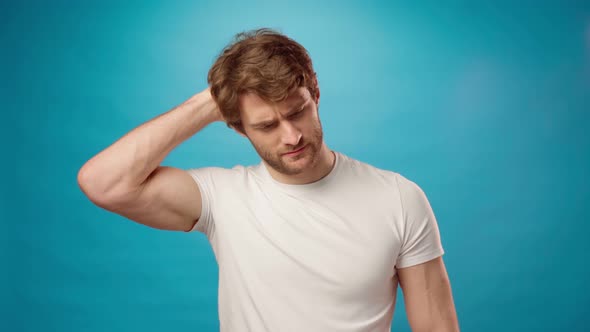 Thoughtful Young Man Itching His Head Blue Background