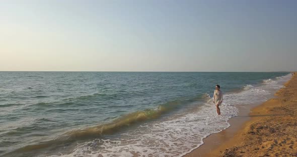 girl on the beach in a dress near the sea