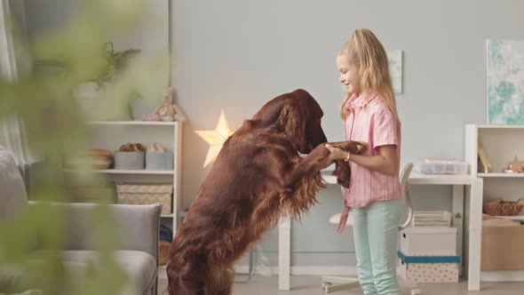 Girl Dancing with Her Dog at Bedroom