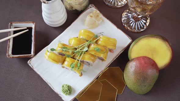 Close-up, mango sushi set on white clay plate