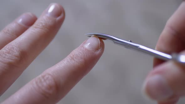 Women Hands are Cutting Fingernails Nail Scissors