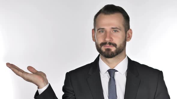 Portrait of Beard Businessman Showing Product at Side White Background