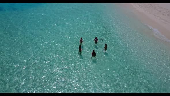 Beautiful women happy together on tranquil island beach adventure by blue sea with white sandy backg