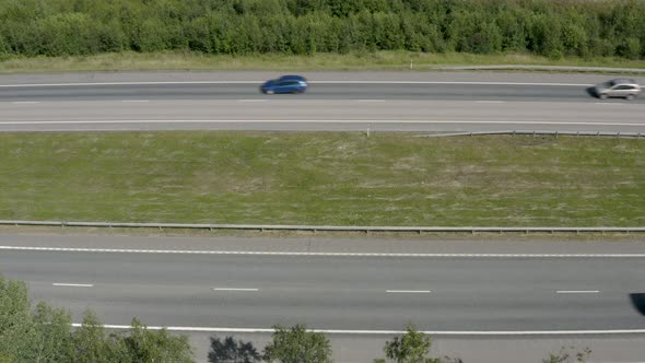 Top down aerial view of cars passing quickly on a motorway in Finland near Kerava.