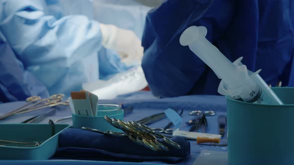 Surgeons working during open heart surgery, close up on hands and instruments.