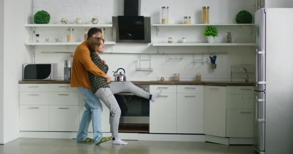 Young Mixed Race Couple Is Dancing in Kitchen