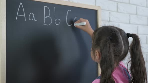 Child Write an Alphabet