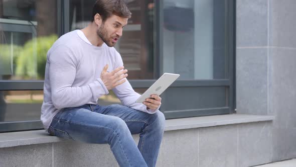 Loss Man Frustrated By Results on Laptop While Sitting on Stairs