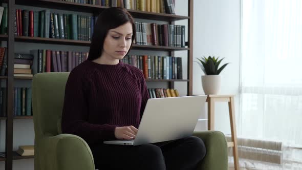 Casual Sitting Woman Closing Laptop and Leaving Sofa in Office