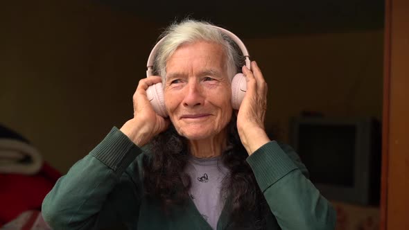 Old Woman Uses Wireless Earphones