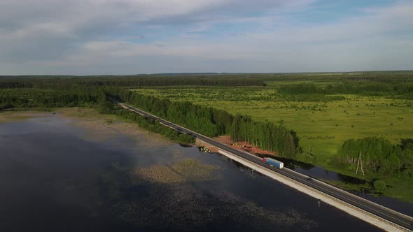 Bridge Near Lake and Field in Countryside