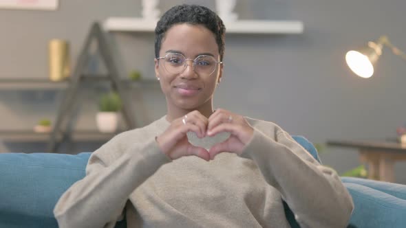 Portrait of African Woman Making Heart Shape with Hands