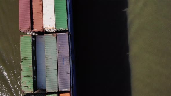 Shipping Containers Loaded Into Vessel Traveling At Oude Maas River During Sunny Day In Netherlands.