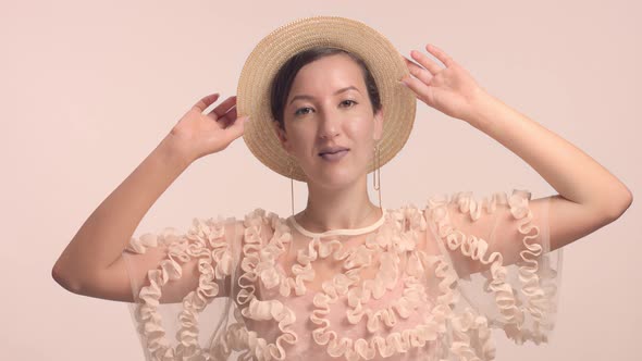 a Young Moroccan Woman Wears a Hat in the Studio and Monochrome Makeup