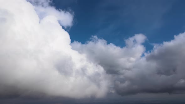 Aerial View From Airplane Window at High Altitude of Earth Covered with Puffy Cumulus Clouds Forming