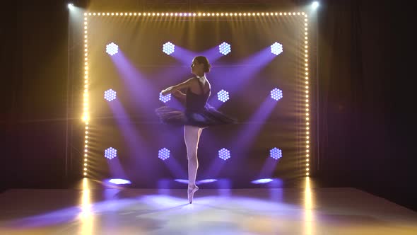 Young Flexible Ballerina in Black Tutu and Pointe Ballet Shoes. Graceful Dancing of Elements