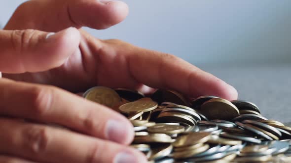 Gold and Silver Coins in Hand