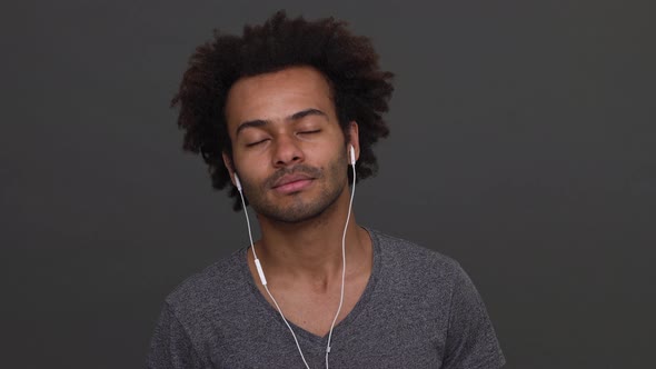 Dark Skinned Man Young Man Listening to the Music with Headphones Then Taking It Off and Get Angry