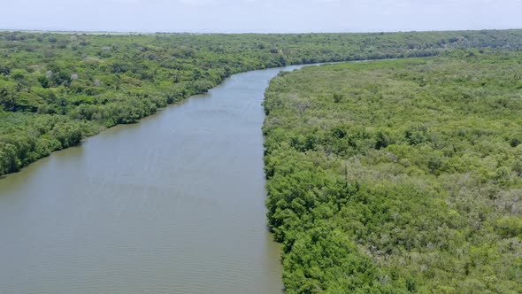 Aerial flyover idyllic Rio Soco in wilderness during sunny day in nature of Dominican Republic