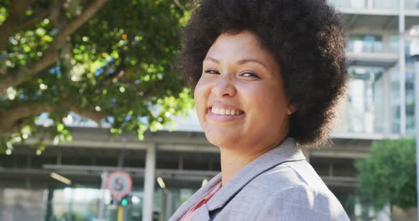 Portrait of happy plus size biracial woman in city