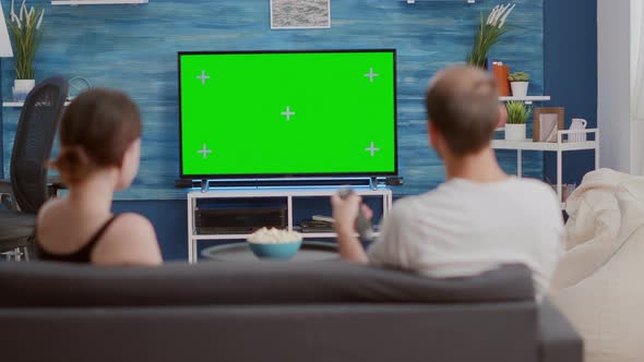 Back View of Young Woman Asking Boyfriend to Change Tv Channel While Spending Time