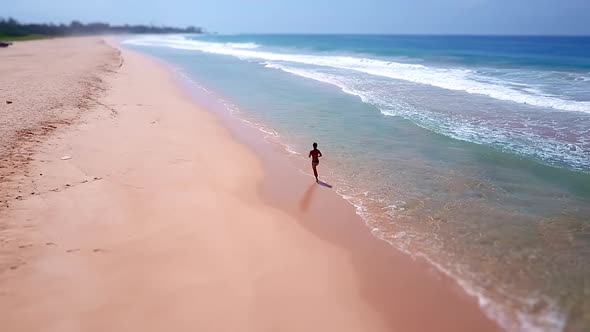 Sporty Asian Woman Running Ocean Beach Bikini