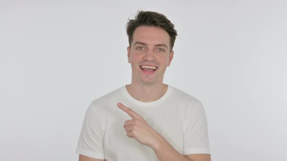 Young Man Pointing on Side on White Background