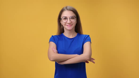 Portrait Cheerful Confident Feminine in Eyeglasses Posing with Crossed Hands Isolated Orange Studio