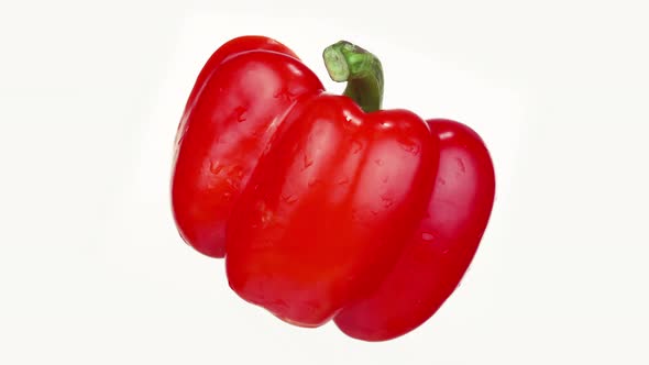 Half of Red Bell Pepper with Green Stem and Seeds on White