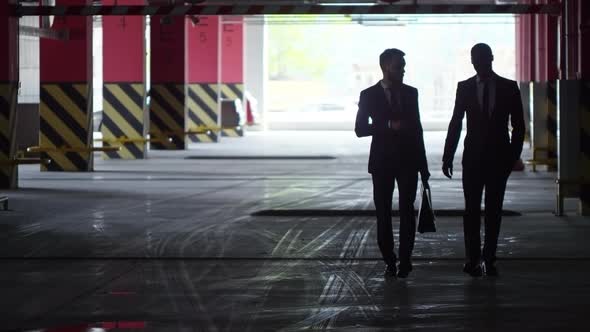 Businessmen Walking in Underground Car Park