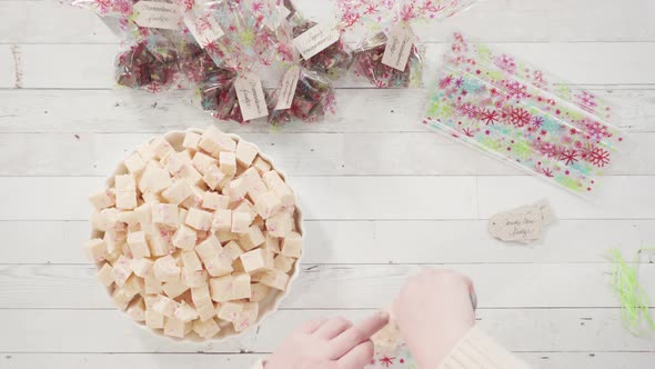 Flat lay. Step by step. Packaging homemade candy cane fudge into small gift bags.