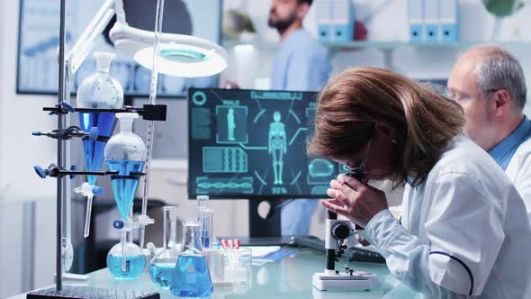 Female and Male Scientists Working in Modern Laboratory