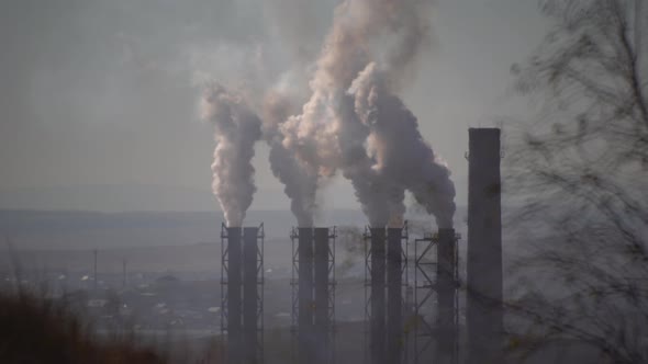 large amount of smoke and soot is emitted from the factory pipes of the metallurgical plant