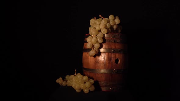 Backward rotating wine barrel with some grapes.