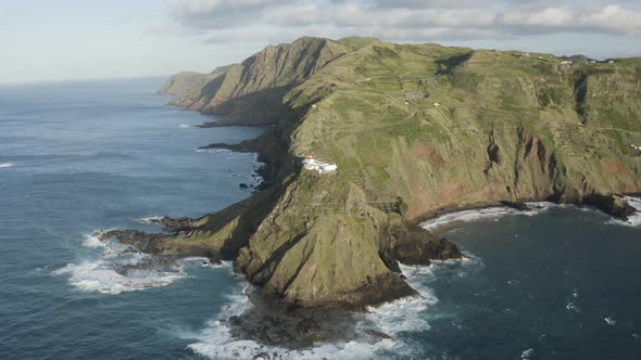 Aerial View of lighthouse on the peak of the cliff by the ocean, Santo Espirito. alt