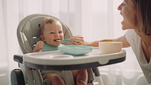 Baby Sits at a Children's Little Table