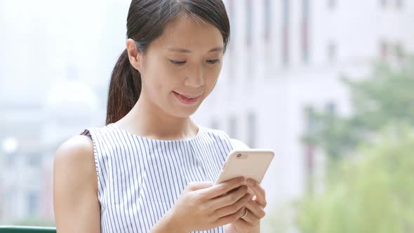 Woman use of mobile phone in Central of Hong Kong 