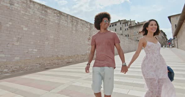 Romantic Couple Walking Feeling Free and Happy To the Main Square in Rural Town of Assisi.Medium