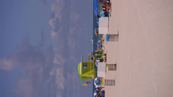 Vertical Video Tourism In Miami Beach. Crowds Of People On Summer Vacation