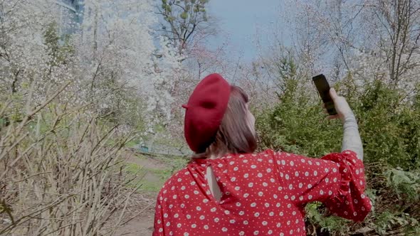 European Girl is Talking Facetime in Protective Face Mask in Outdoors