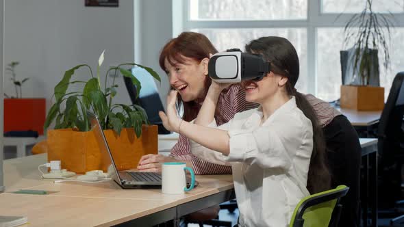 Two Female Business Colleagues Trying 3d Vr Glasses at Work